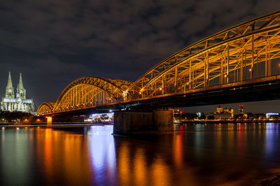 Illuminated bridge over river at night. cologne, germany