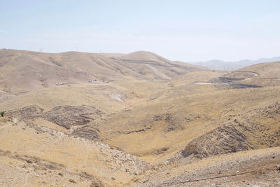 Scenic view of arid landscape against sky