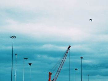 Low angle view of street light against cloudy sky