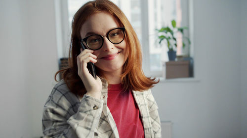 Portrait of young woman using mobile phone