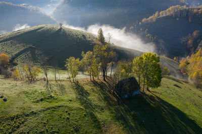 Mountain countryside homestead in the autumn. wooden barns, aerial drone view. transylvania, romania