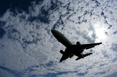 Low angle view of airplane flying in sky