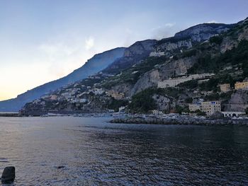 Scenic view of sea and buildings against sky