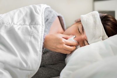 Midsection of man and woman lying on bed