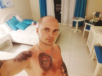 Portrait of shirtless man at home