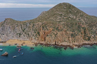 People on rock by sea