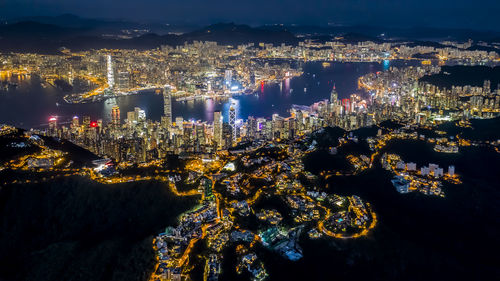 High angle view of city lit up at night