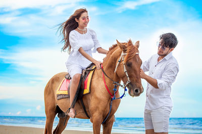 Young man riding horse in sea