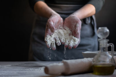 Woman baker with flour in her hands