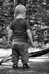 Rear view of boy standing outdoors