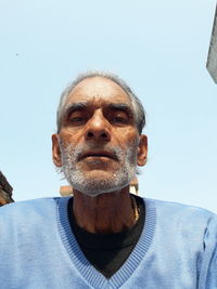 Low angle portrait of man against sky