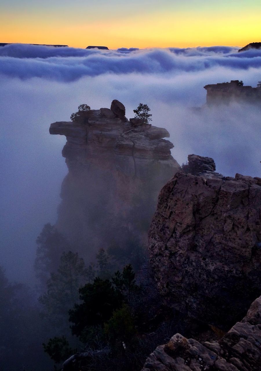 SCENIC VIEW OF MOUNTAINS AGAINST CLOUDY SKY AT SUNSET