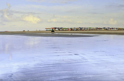 People on beach against sky