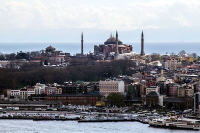 Hagia sophia in city by sea against sky