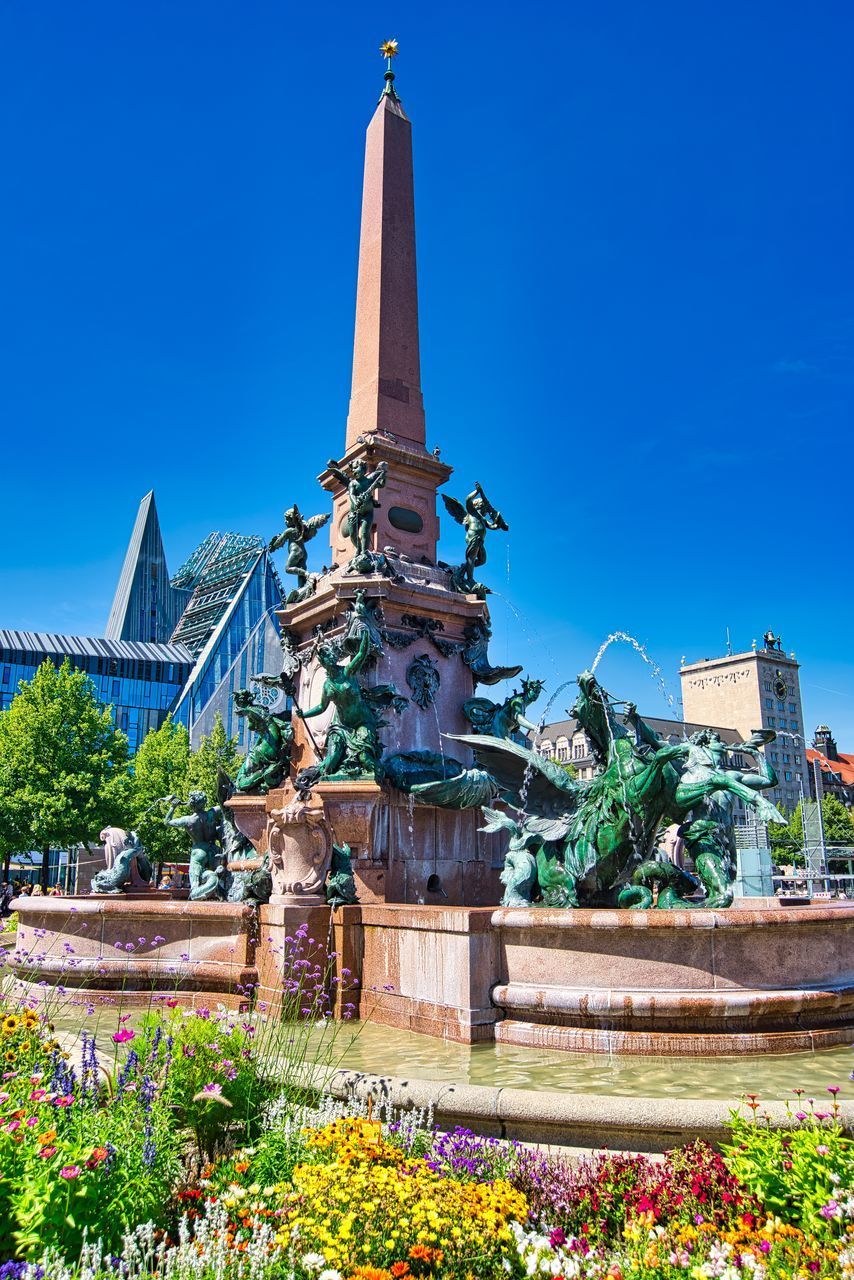 VIEW OF STATUE OF PLANTS AGAINST BLUE SKY