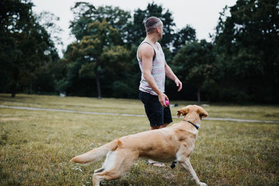 Woman with dog on field