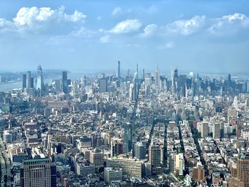 High angle view of modern buildings in city against sky