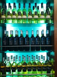 Row of bottles on shelf at home