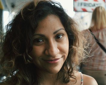 Close-up portrait of young woman smiling while standing outdoors