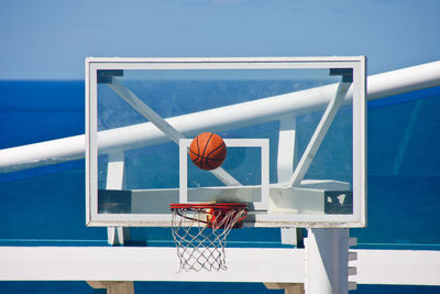 Low angle view of basketball hoop against blue sky