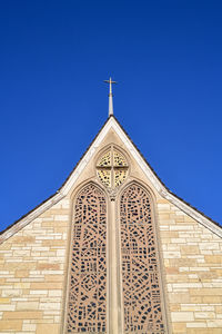 Low angle view of church building against clear blue sky