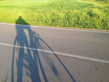 Low section of man shadow on road