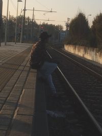 Side view of man on railroad station platform