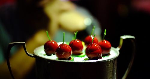 Close-up of red candies on container