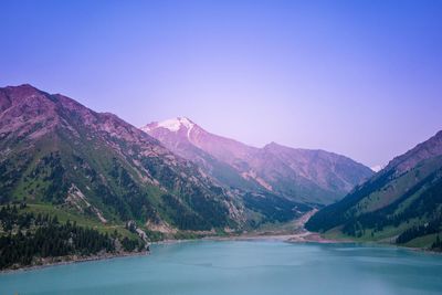 Scenic view of mountains against clear blue sky