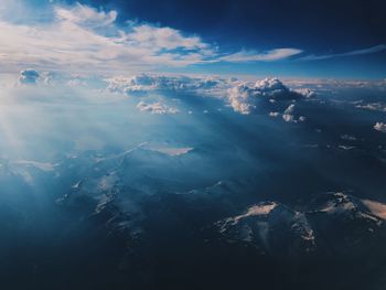 Aerial view of sea and mountains against sky