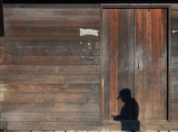 Side view of woman looking at entrance of building