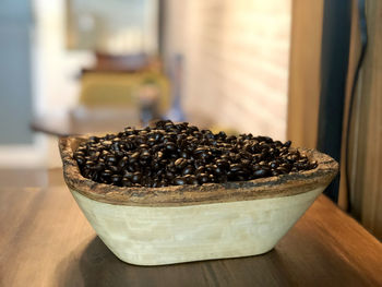 Close-up of coffee beans in bowl on table