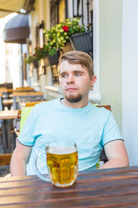 Portrait of young man sitting at table