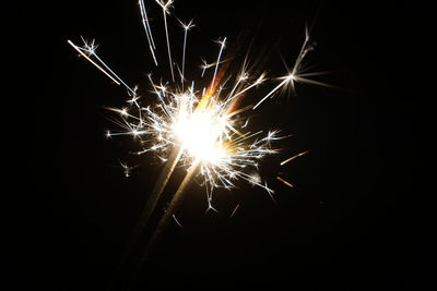 Low angle view of firework display at night