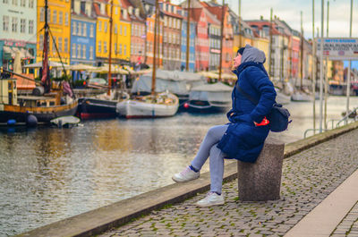 Rear view of man in canal during winter