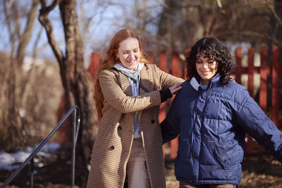 Smiling female friends in park