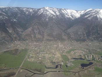 Aerial view of agricultural field against mountain range