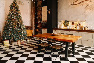 The interior of a christmas decorated kitchen in the loft style in a cozy house