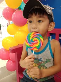 Close-up of boy with balloons