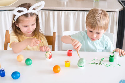 Portrait of cute girl playing with toys at home