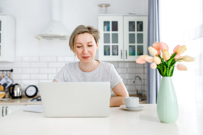 Young woman using smart phone at home