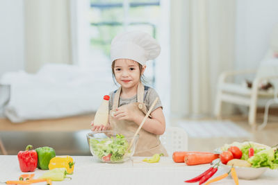 Baby girl eating food at home