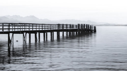 Pier on lake against sky