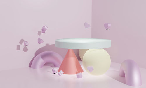 Close-up of colored pencils on table against wall