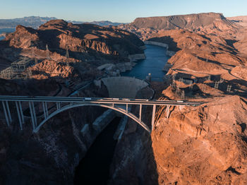 Bridge over mountains against sky