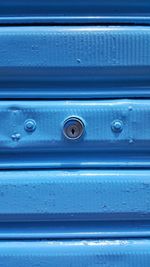 Close-up of keyhole on blue metal
