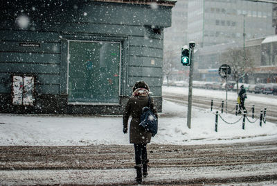 Full length of woman on city street during winter