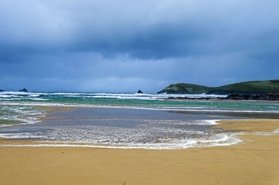 View of beach against cloudy sky