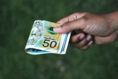 Close-up of person holding paper currency