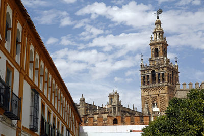 Low angle view of cathedral against cloudy sky